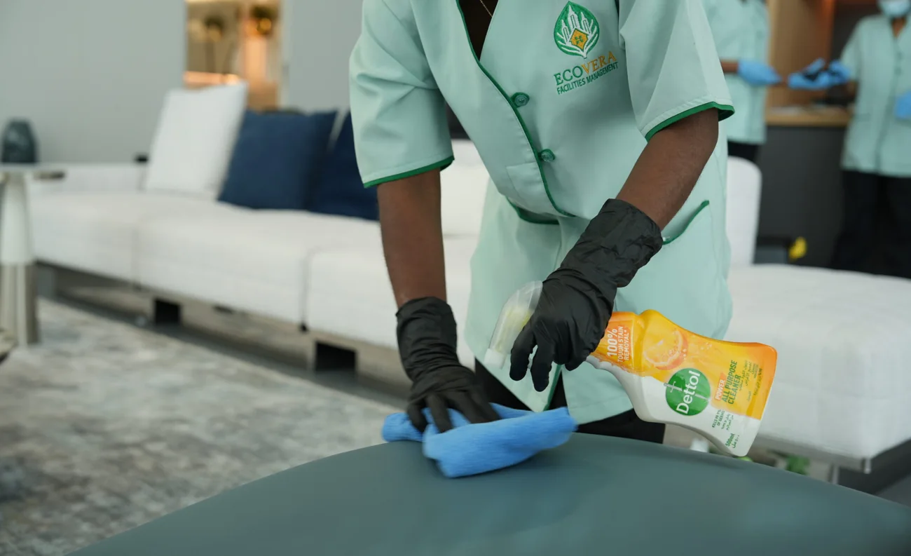 An operator in an Ecovera uniform cleaning a countertop
